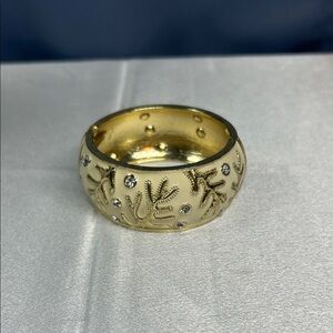 Hinged cream enamel bangle bracelet gold-tone leaf motifs and crystal accents
